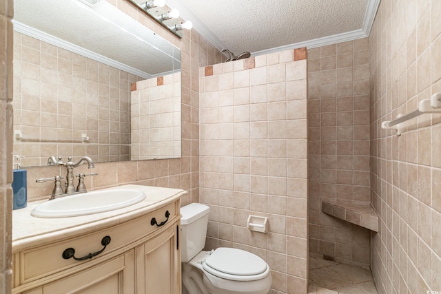 bathroom with walk in shower, crown molding, a textured ceiling, vanity, and tile walls