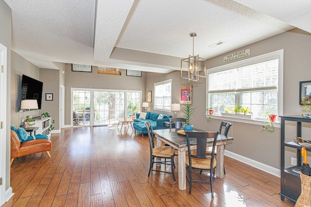 dining room with a healthy amount of sunlight and wood-type flooring