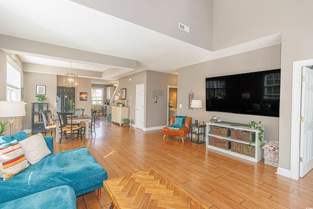 living room featuring a notable chandelier and wood-type flooring