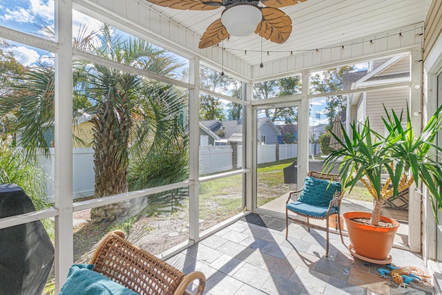 sunroom featuring ceiling fan and wood ceiling