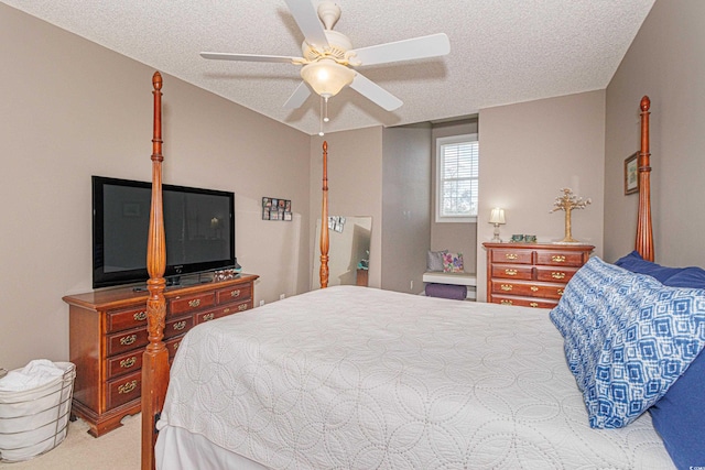 carpeted bedroom with ceiling fan and a textured ceiling