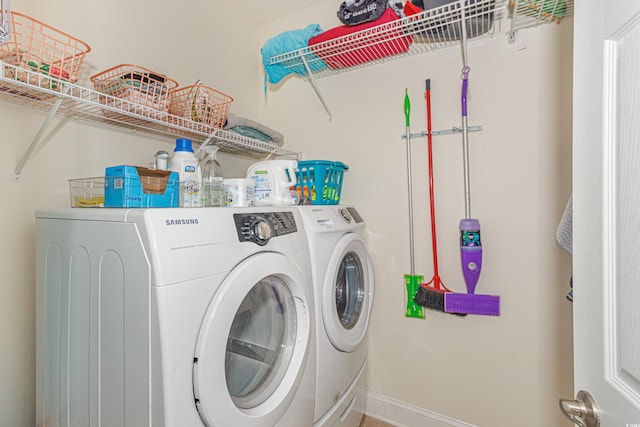 clothes washing area with washing machine and dryer