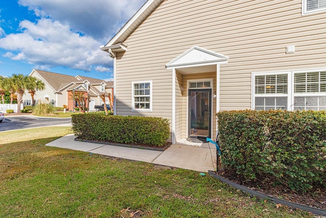 entrance to property with a yard