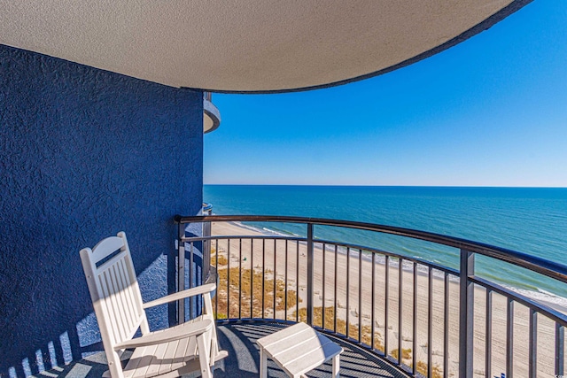 balcony featuring a beach view and a water view