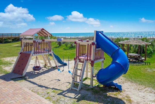 view of playground with a lawn and a water view