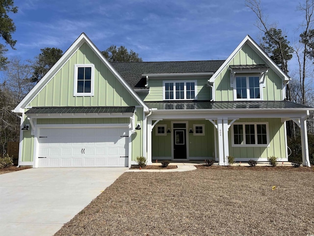 modern inspired farmhouse featuring a porch, driveway, roof with shingles, board and batten siding, and a standing seam roof