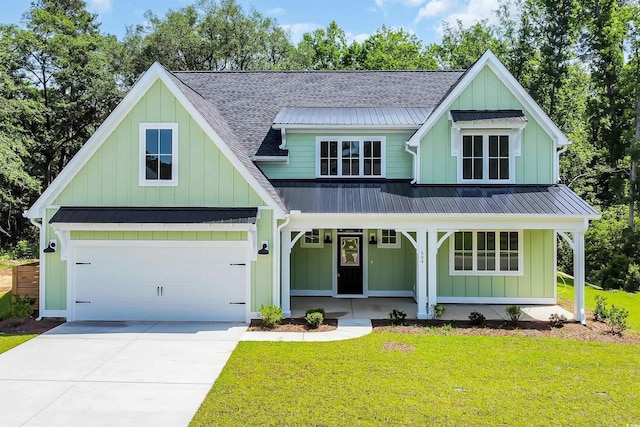 604 Mccown Dr, Conway, SC 29526 - view of front facade with board and batten siding, concrete driveway, a standing seam roof, covered porch, and roof with shingles