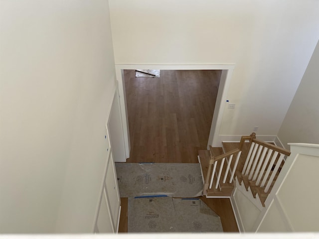 staircase with wood finished floors