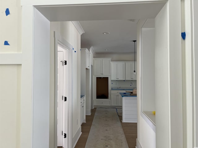 hall featuring ornamental molding and light wood finished floors