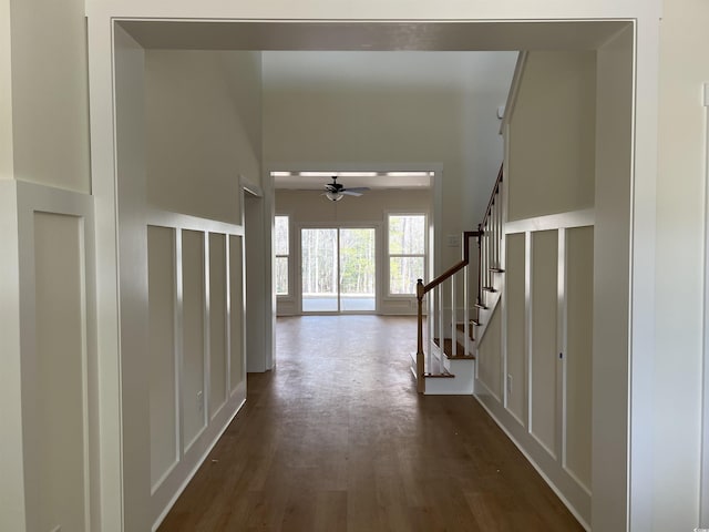 hall with dark wood-style flooring and stairway