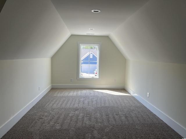 bonus room with lofted ceiling, carpet flooring, visible vents, and baseboards