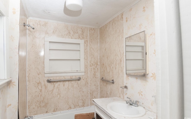 bathroom featuring vanity, ornamental molding, a textured ceiling, and built in shelves