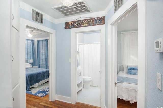 hallway featuring hardwood / wood-style floors and a textured ceiling