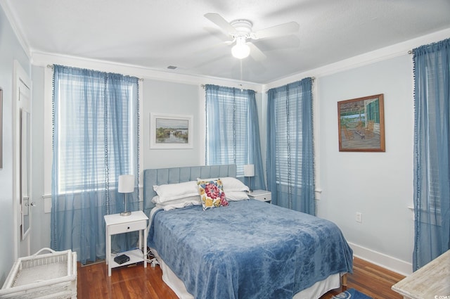 bedroom with dark hardwood / wood-style flooring, ceiling fan, and crown molding