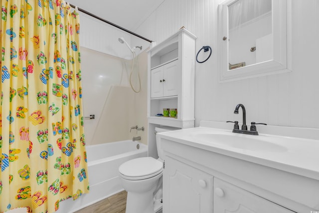 full bathroom with hardwood / wood-style floors, vanity, toilet, and shower / bath combo with shower curtain