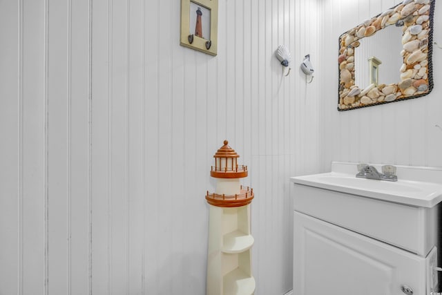 bathroom featuring wood walls and vanity