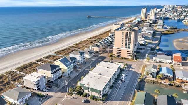 birds eye view of property featuring a view of the beach and a water view