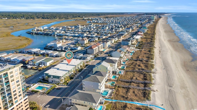 birds eye view of property featuring a water view and a view of the beach