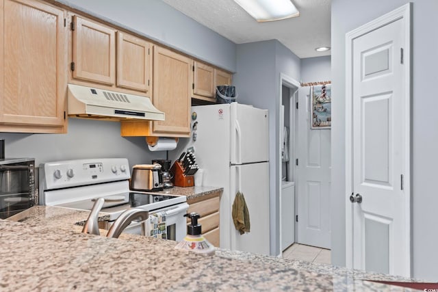 kitchen with light brown cabinets, light tile patterned floors, and white appliances