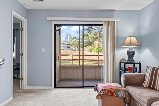 doorway to outside featuring light colored carpet