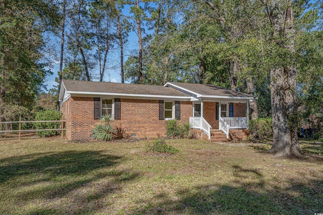 view of front of home featuring a front lawn and covered porch