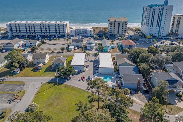 aerial view with a water view and a beach view