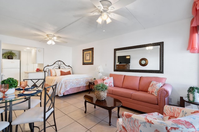 bedroom with white refrigerator, ceiling fan, and light tile patterned flooring