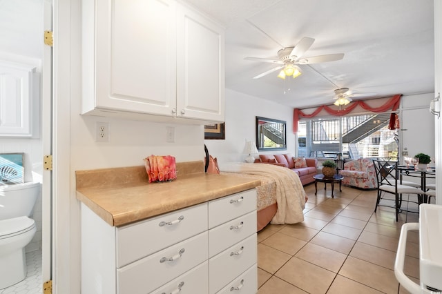 bedroom with light tile patterned floors and ceiling fan