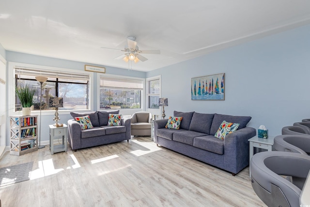 living room featuring ceiling fan and light hardwood / wood-style floors