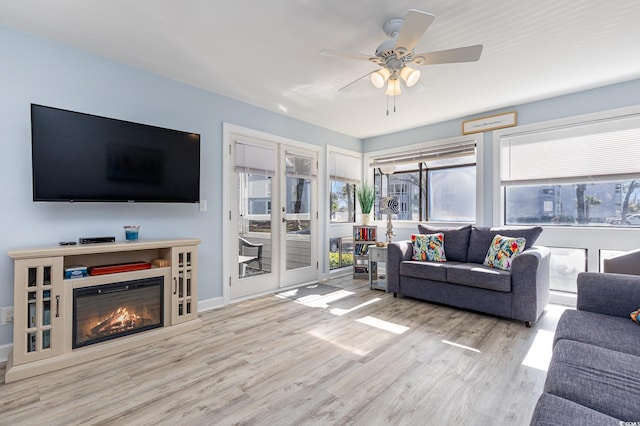 living room featuring light hardwood / wood-style flooring and ceiling fan