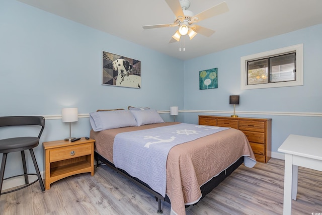 bedroom with ceiling fan and light hardwood / wood-style floors