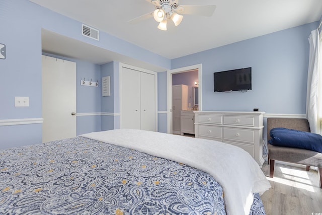 bedroom featuring hardwood / wood-style flooring, a closet, and ceiling fan