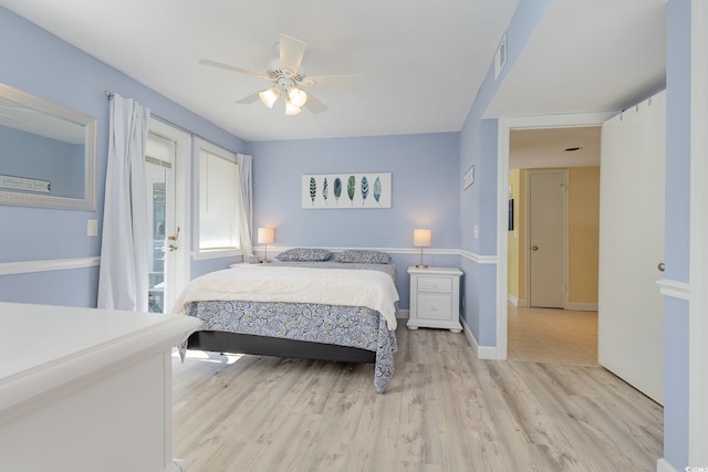 bedroom with light hardwood / wood-style floors and ceiling fan