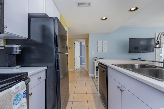 kitchen with white cabinetry, sink, light tile patterned flooring, and black appliances