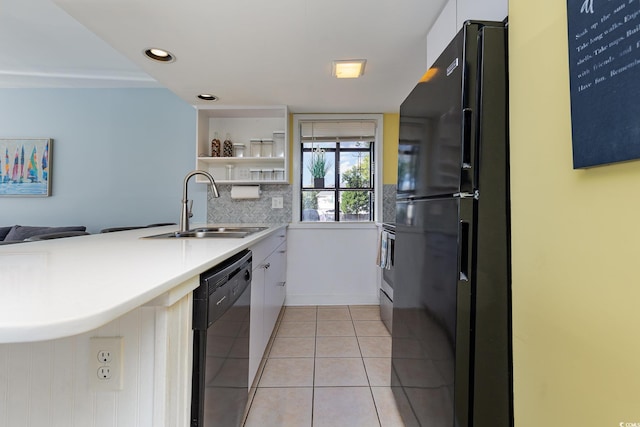 kitchen featuring sink, black appliances, white cabinets, light tile patterned flooring, and kitchen peninsula