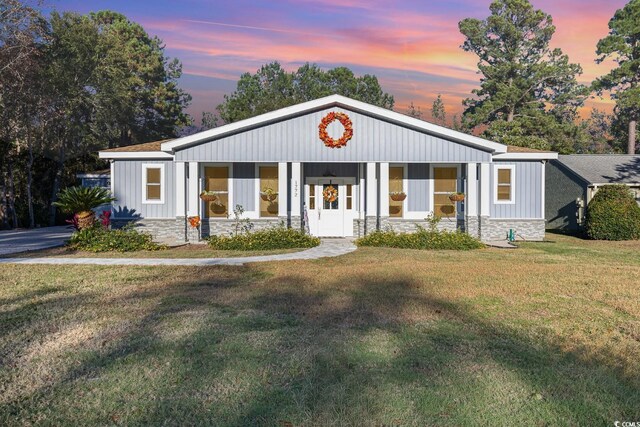 view of front of home featuring a yard and a porch