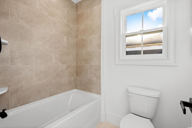 bathroom featuring shower / bathtub combination and toilet