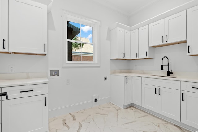 interior space with white cabinetry, crown molding, and sink