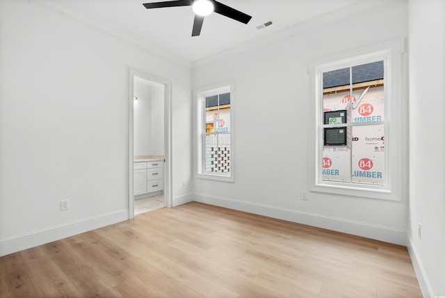 unfurnished bedroom with ensuite bath, ceiling fan, multiple windows, ornamental molding, and light wood-type flooring