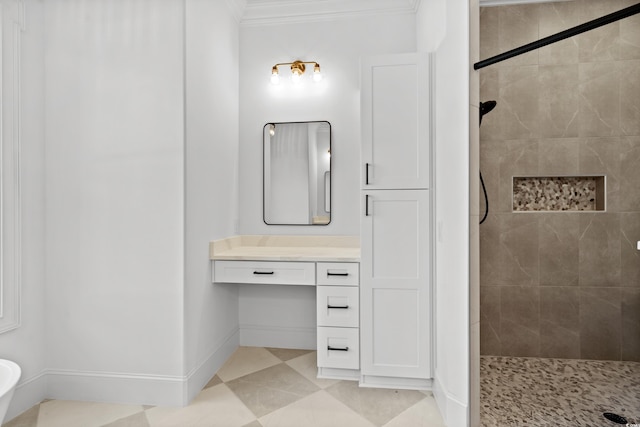 bathroom featuring tile patterned flooring, vanity, a tile shower, and crown molding