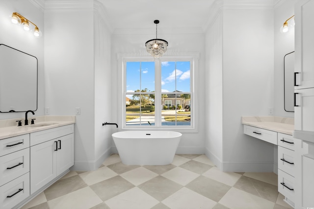 bathroom with vanity, a tub to relax in, ornamental molding, and an inviting chandelier