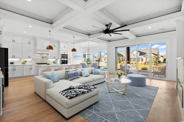 living room featuring beamed ceiling, ornamental molding, coffered ceiling, and light wood-type flooring