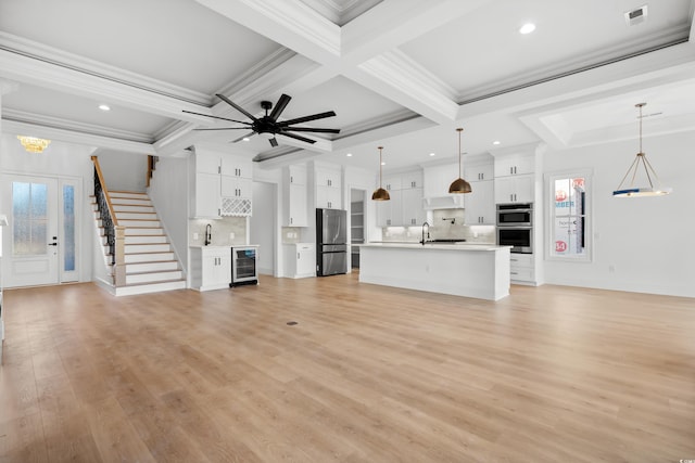 unfurnished living room featuring coffered ceiling, beverage cooler, light wood-type flooring, and beamed ceiling