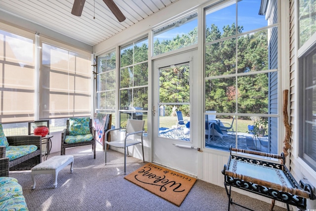 sunroom / solarium with ceiling fan and wooden ceiling