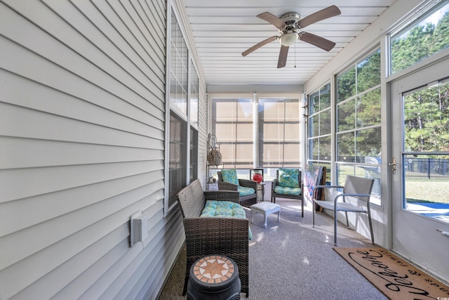 sunroom / solarium featuring ceiling fan