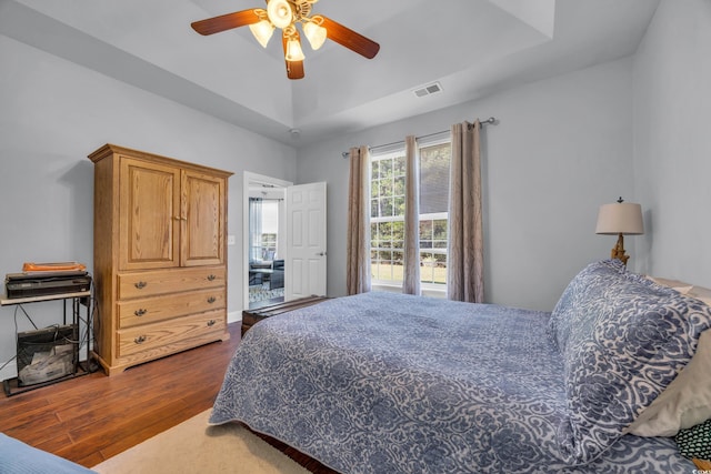 bedroom with ceiling fan and dark hardwood / wood-style flooring