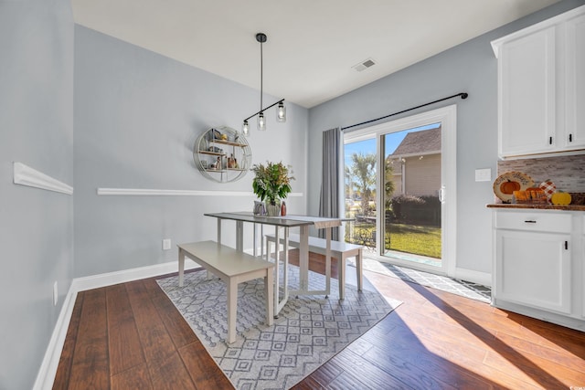 dining space featuring wood-type flooring