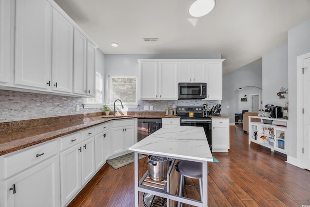 kitchen featuring white cabinets, dark hardwood / wood-style flooring, stainless steel appliances, and stone countertops