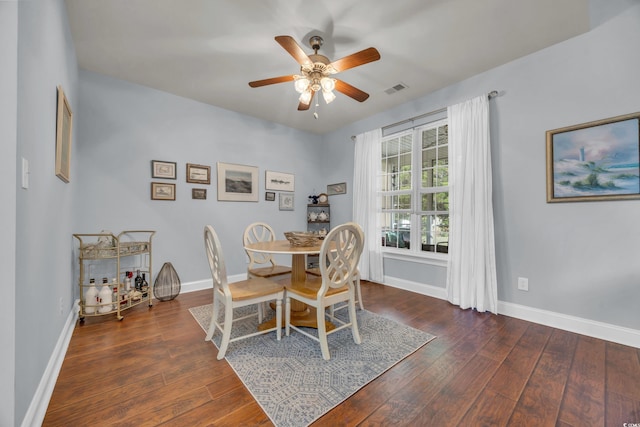 dining area with ceiling fan and dark hardwood / wood-style floors