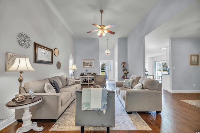 living room with ceiling fan and dark hardwood / wood-style flooring